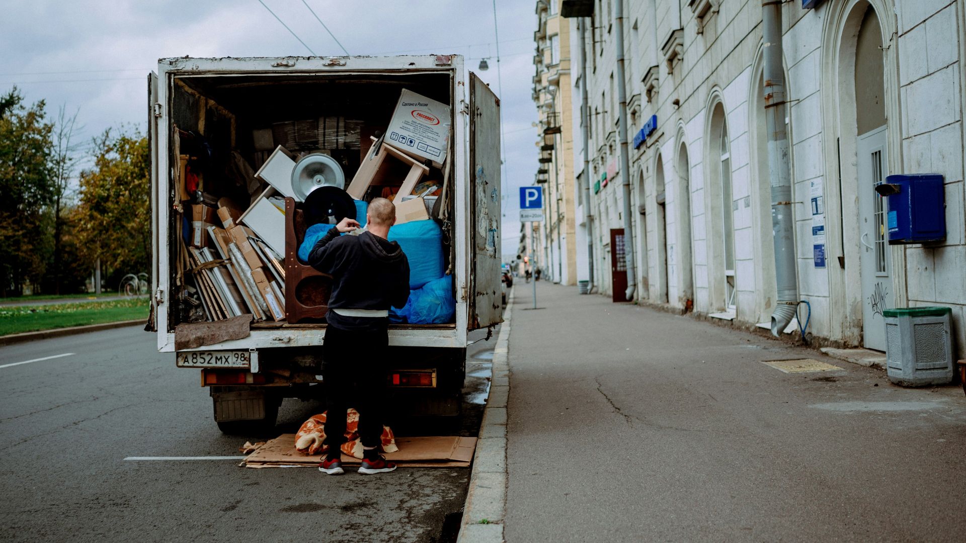 a man unloading furniture from the back of a moving truck