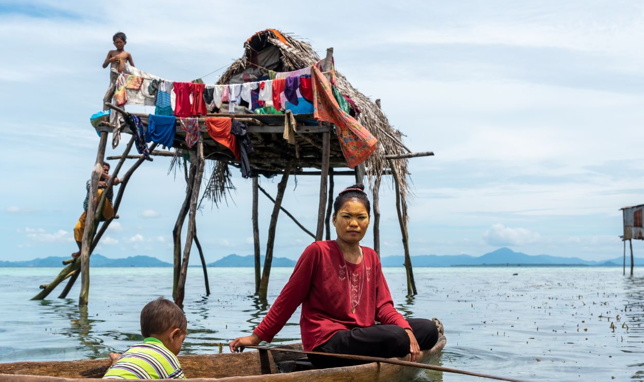 Gettyimages - 1415945148, Sea gypsy or bajau laut woman in a boat in the near stilt house - stock photo Semporna, Malaysia - August 28, 2022: Sea gypsy or bajau laut people paddling a boat in the Celebes sea in Sabah Borneo Malaysia.