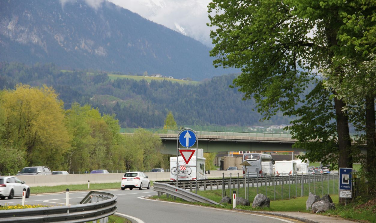 Mountain Highway Scene with Traffic and Signs