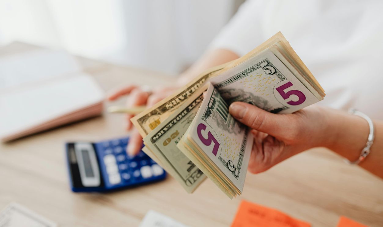 Hand Holding Dollar Bills