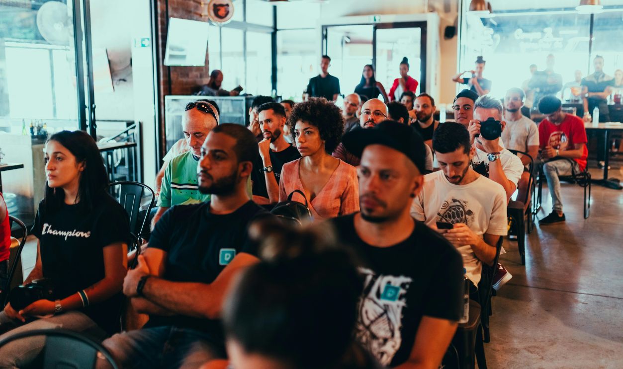 Photo Of People Sitting On Chairs