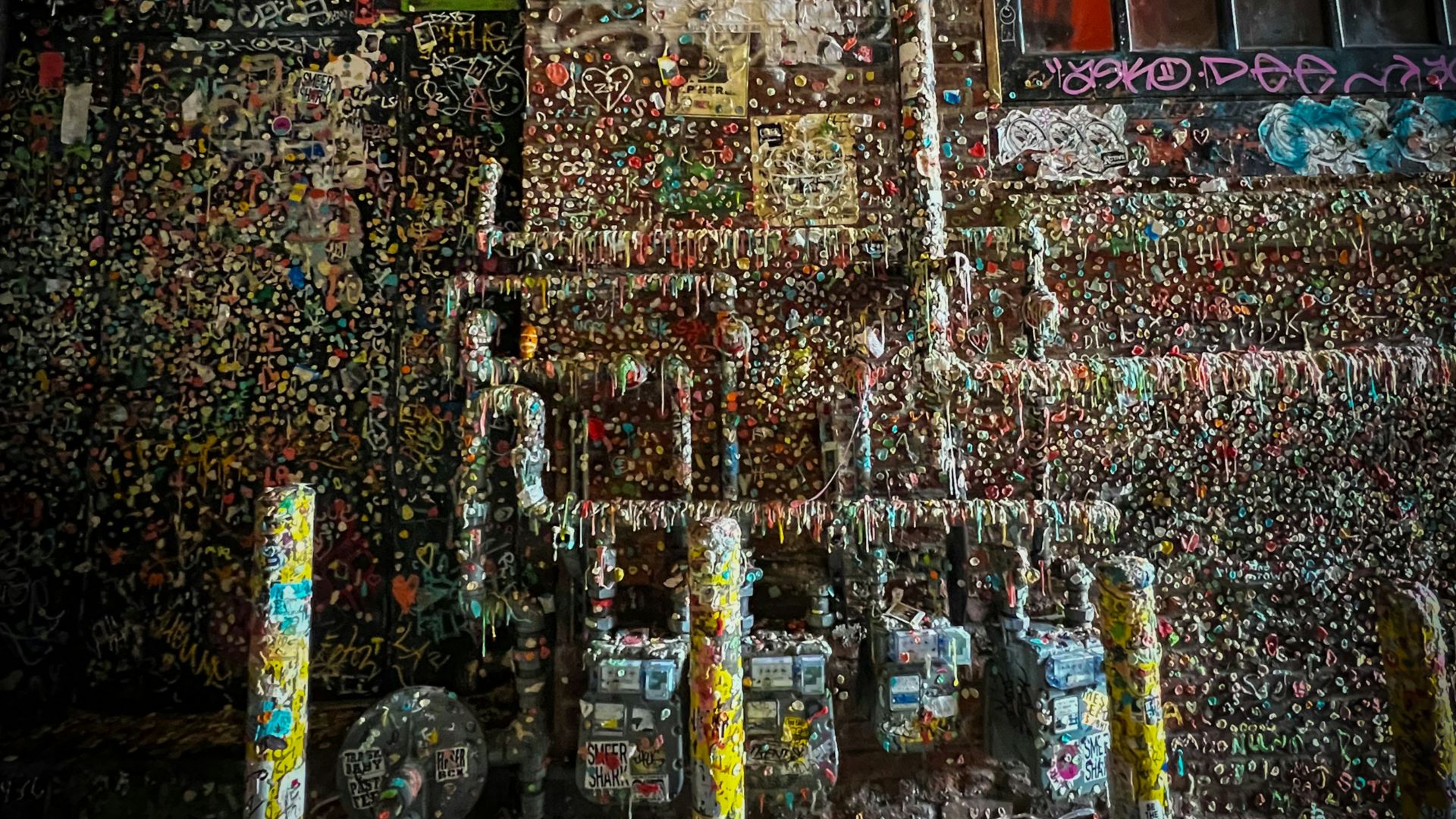 a fire hydrant in front of a building covered in graffiti