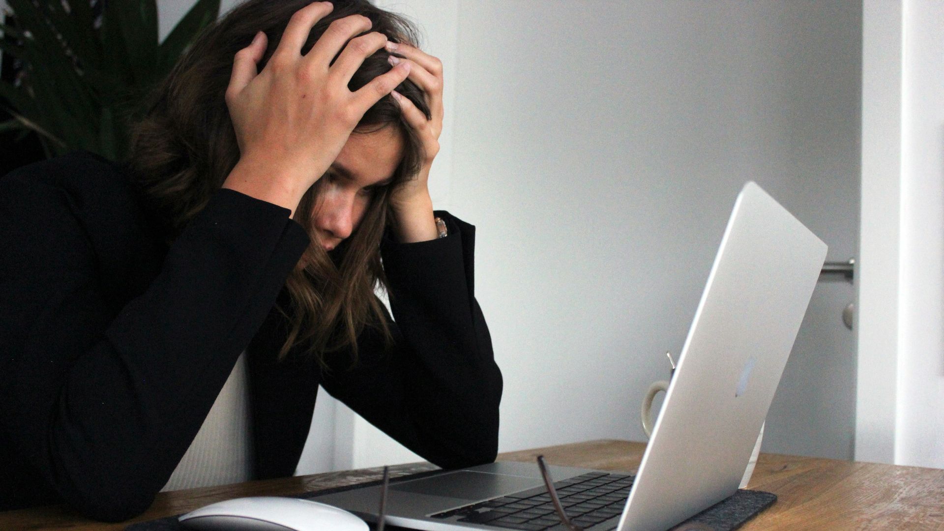 a woman sitting in front of a laptop computer