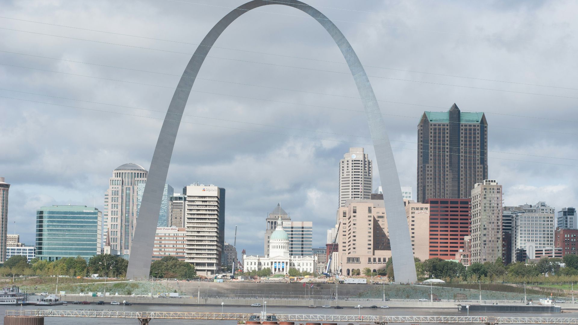 white and brown concrete building under white clouds during daytime