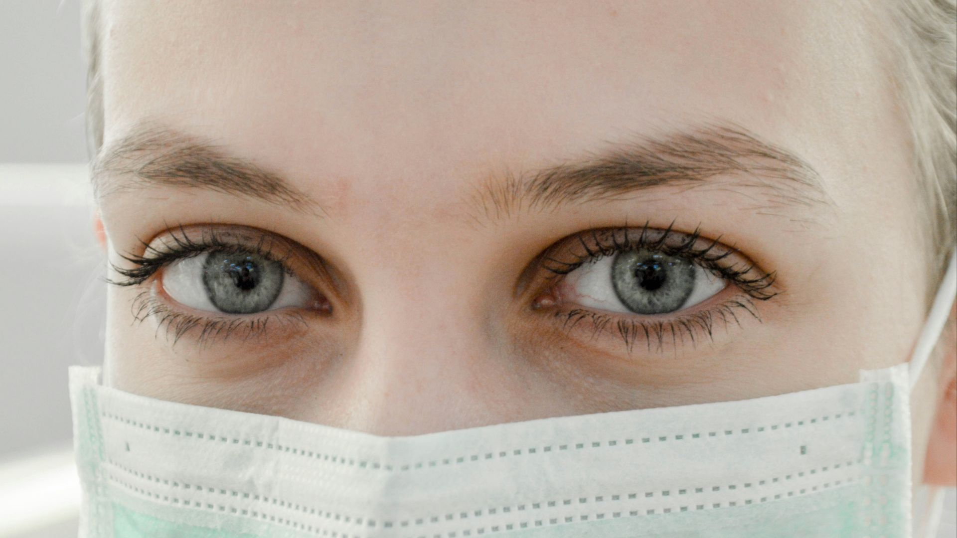 closeup photo of woman's eye wearing mask