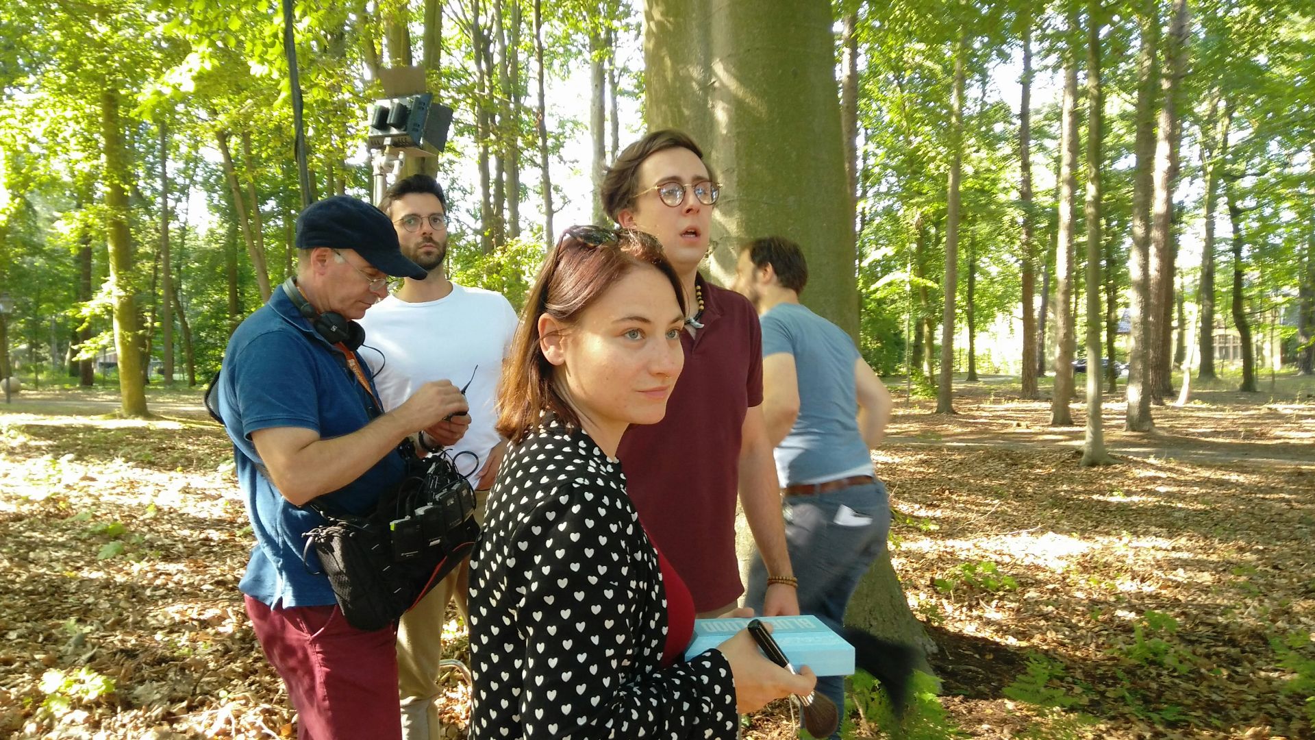 a group of people standing next to each other in a forest