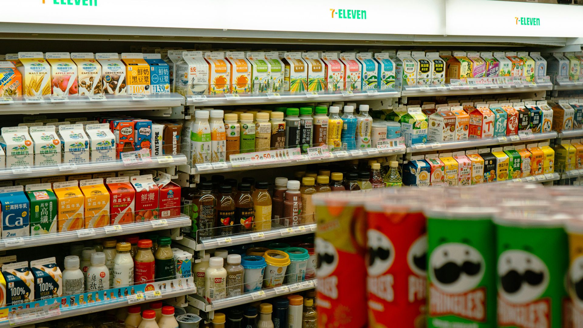 Shelves of snacks and drinks inside a 7-eleven.