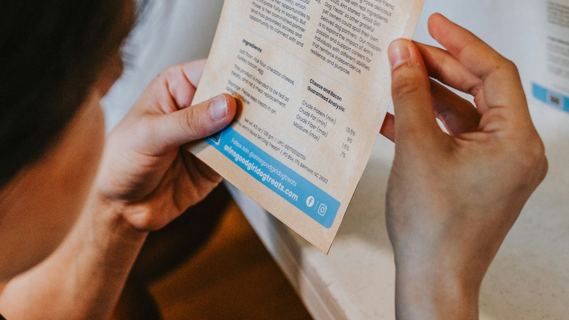 Person reading a pouch labeled arin's story