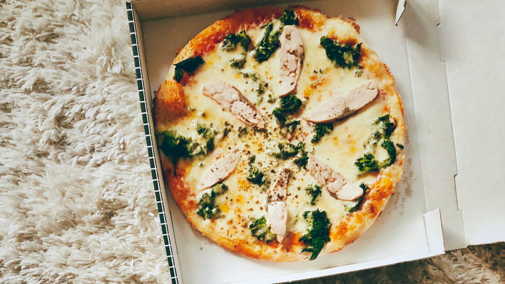 pizza on white cardboard box