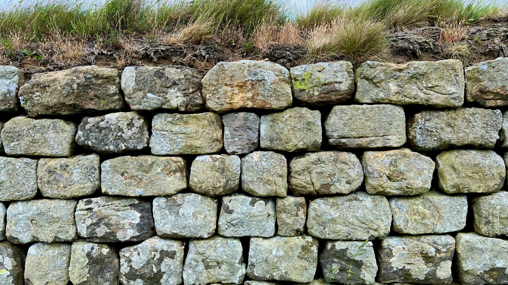 a stone wall with a stone fence