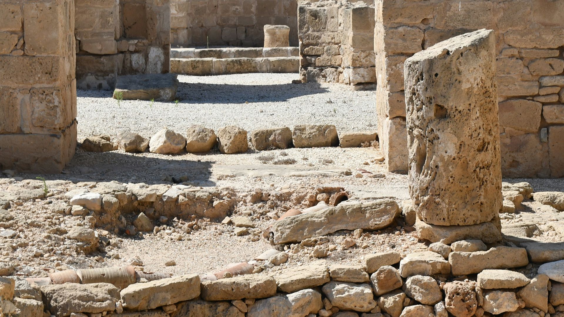 Ancient stone ruins under a clear blue sky.