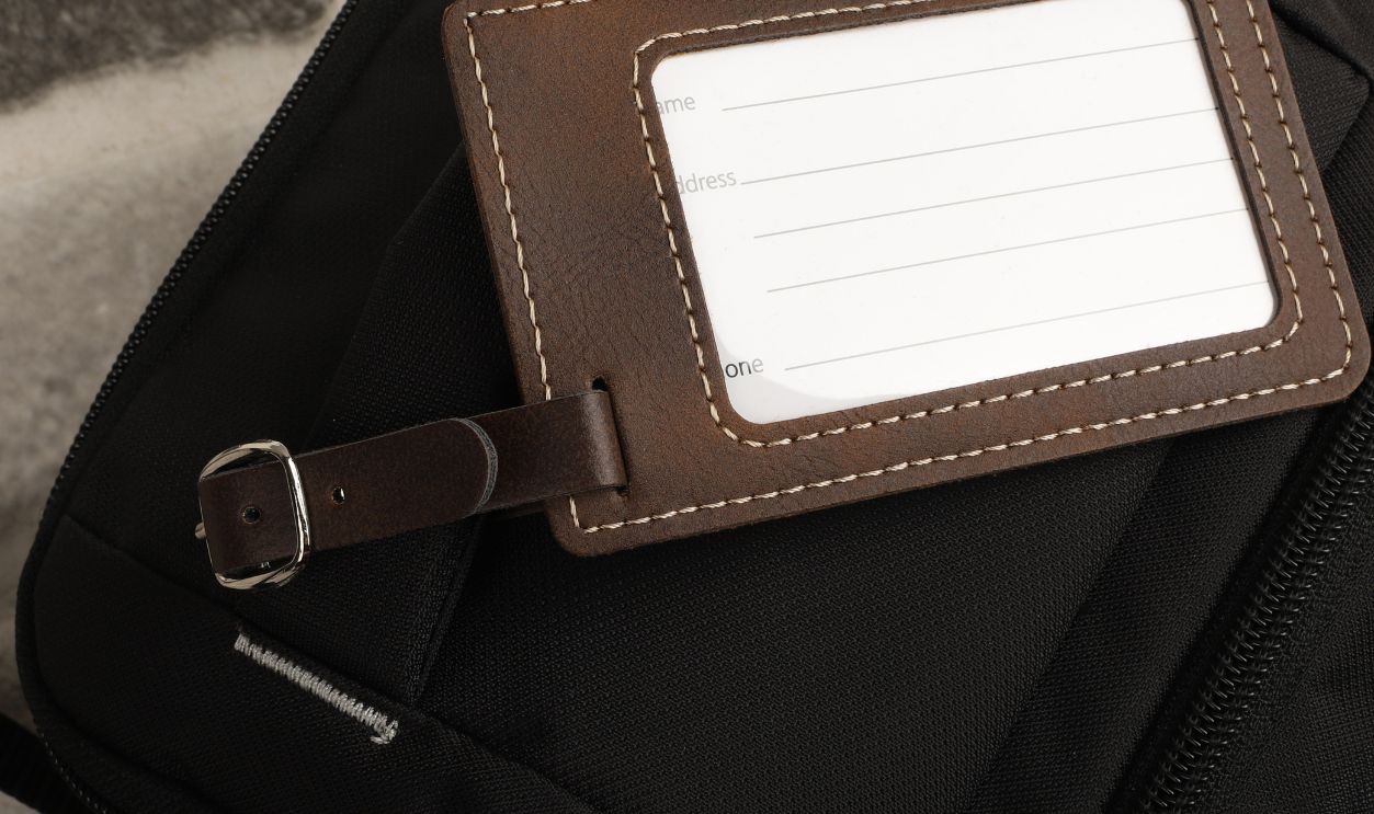 Leather luggage tags in brown colors. Concept shot, top view. Cu