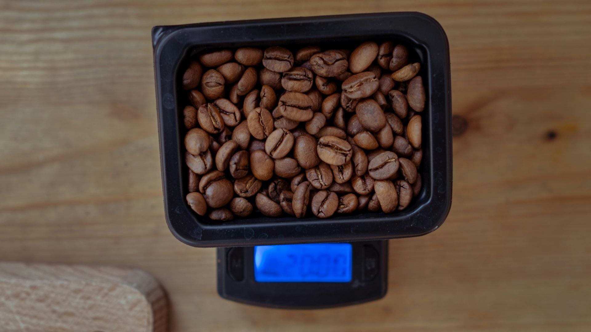 brown almond nuts in black plastic container