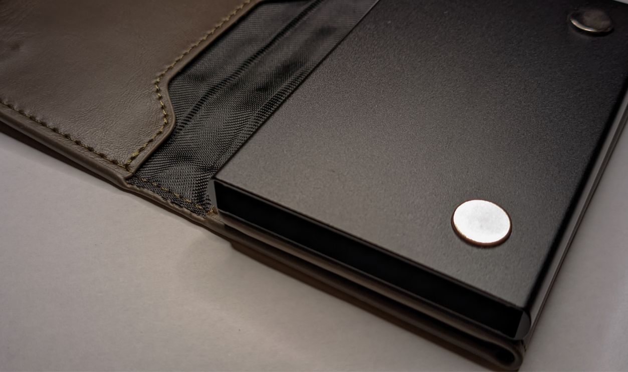 A close-up photo of an RFID-blocking card wallet against a clean white background.