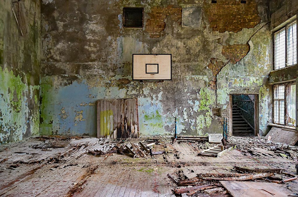 : An assistant holds up a photo showing the city of Pripyat's main square and the 