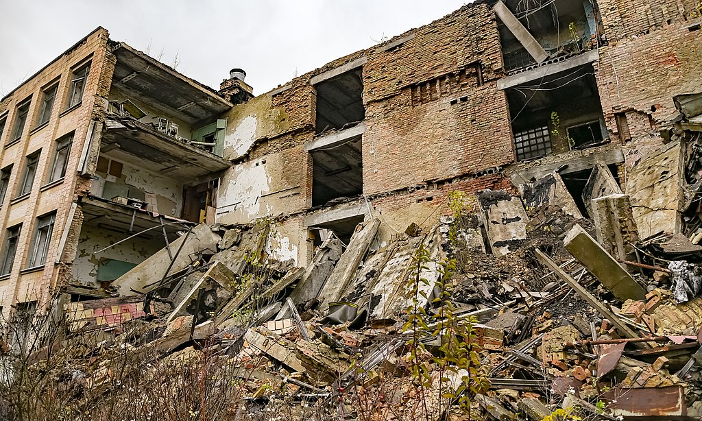 : An assistant holds up a photo showing the city of Pripyat's main square and the 