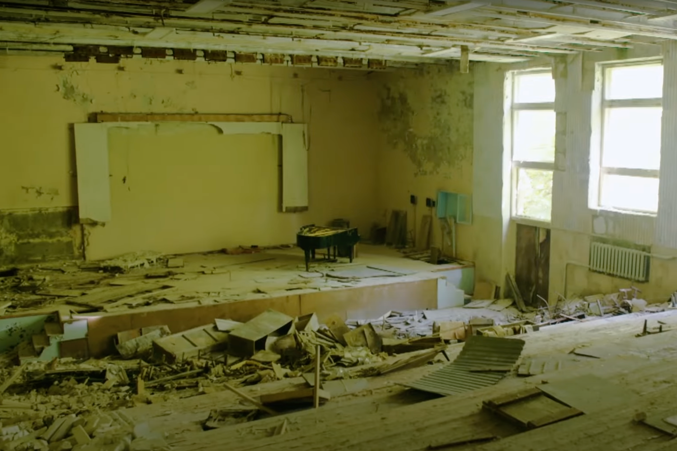 : An assistant holds up a photo showing the city of Pripyat's main square and the 