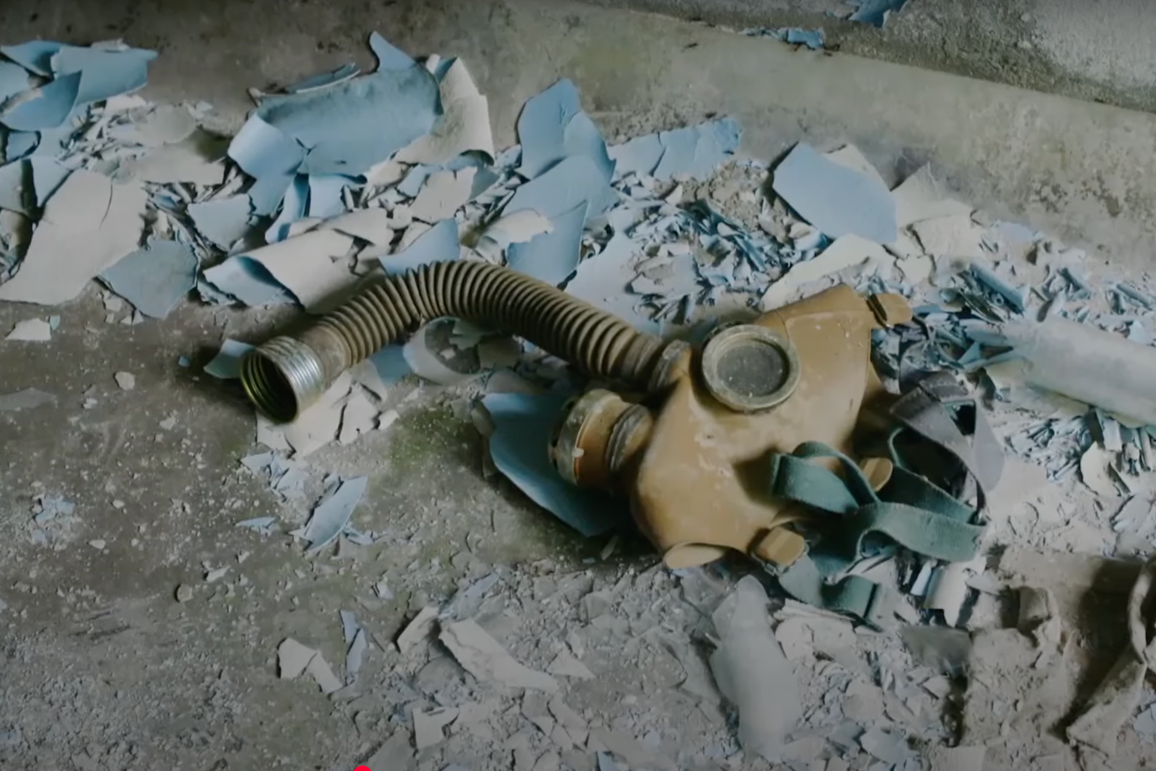 : An assistant holds up a photo showing the city of Pripyat's main square and the 