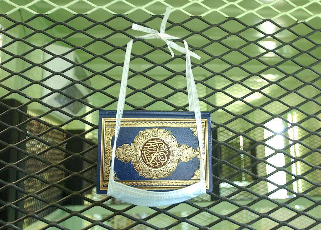 A Koran hung in a surgical mask, in Guantanamo Bay detention camp