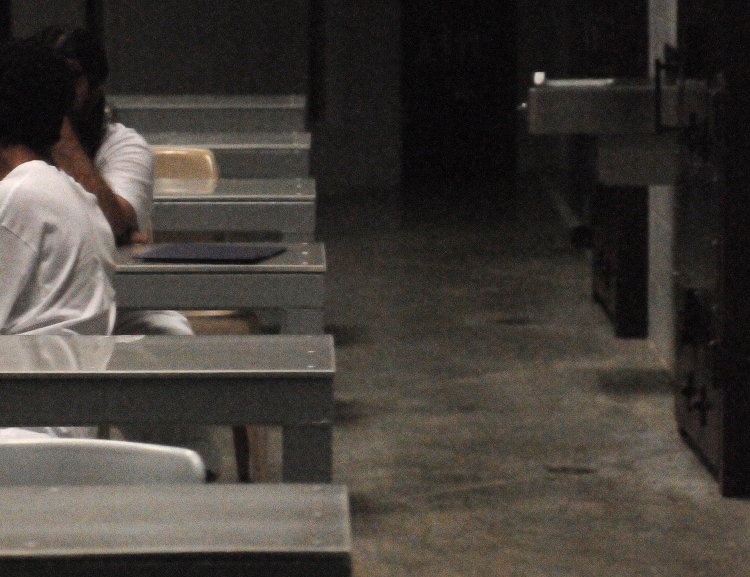 Two detainees converse inside a communal area of Camp Six. Guantanamo Bay