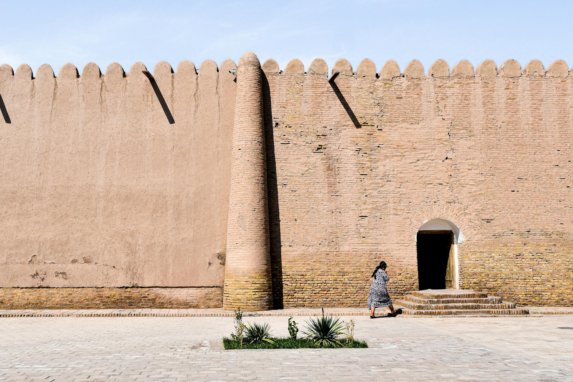 Woman Walking into a Historic Building