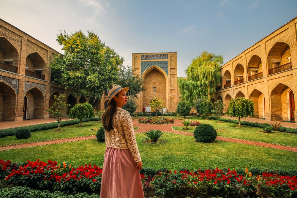 Girl standing in front of Kukeldash Madrasah