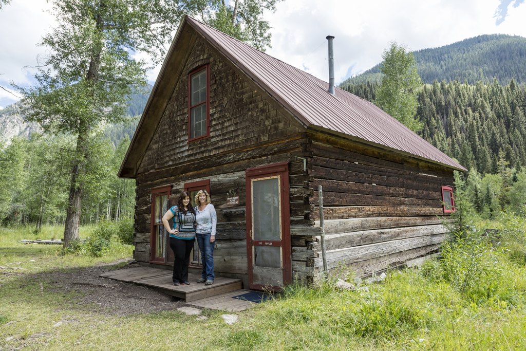 People stand In Front Of The Cabin In Crystal, Colorado