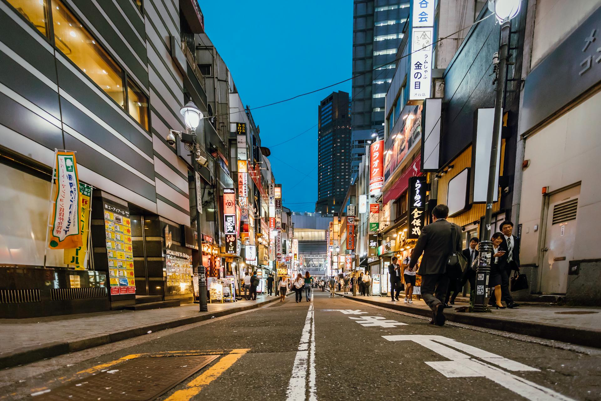 People Walking Between High-rise Buildings in Tokyo
