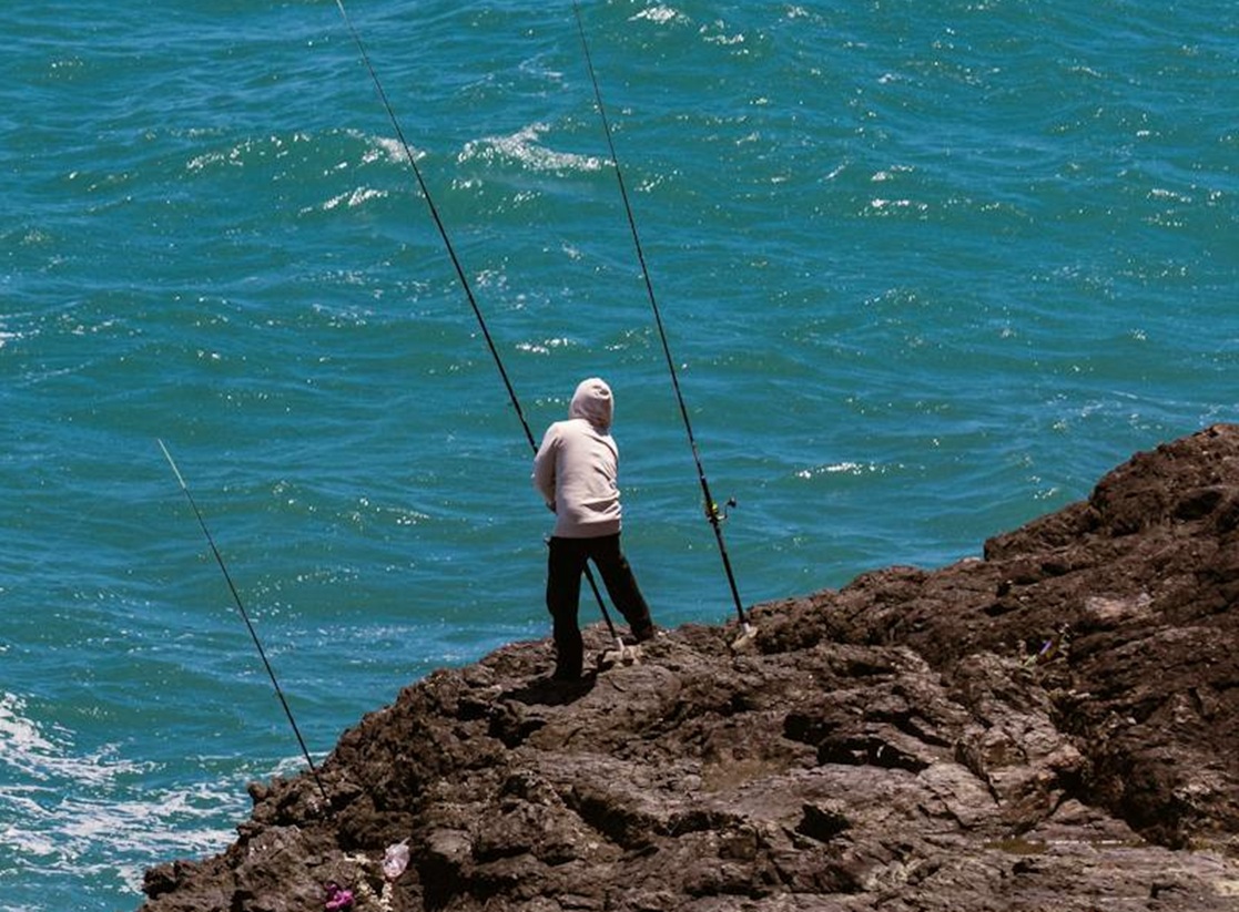 Man fishing from the cliff.