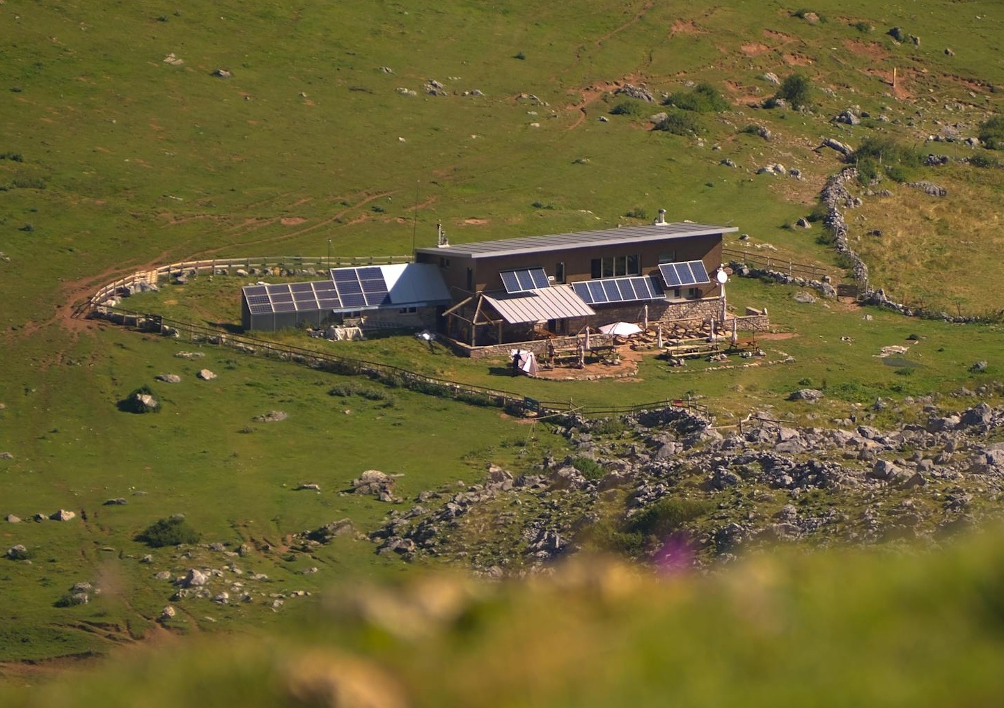 A small house is sitting on top of a hill