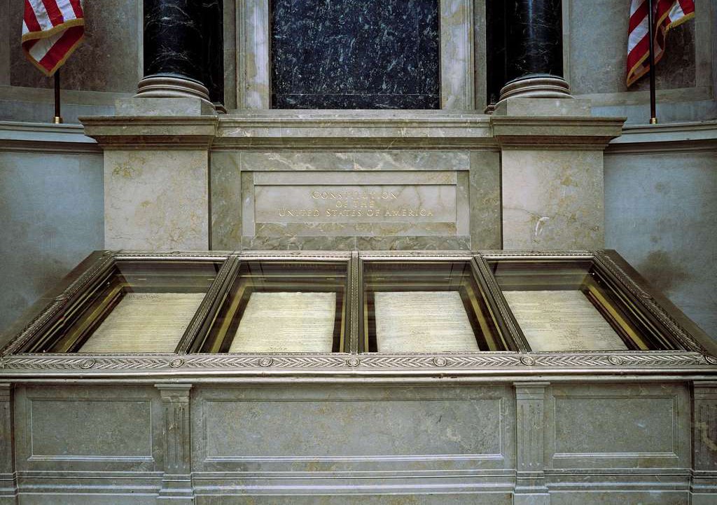 The nation's founding documents displayed under subdued light at the National Archives