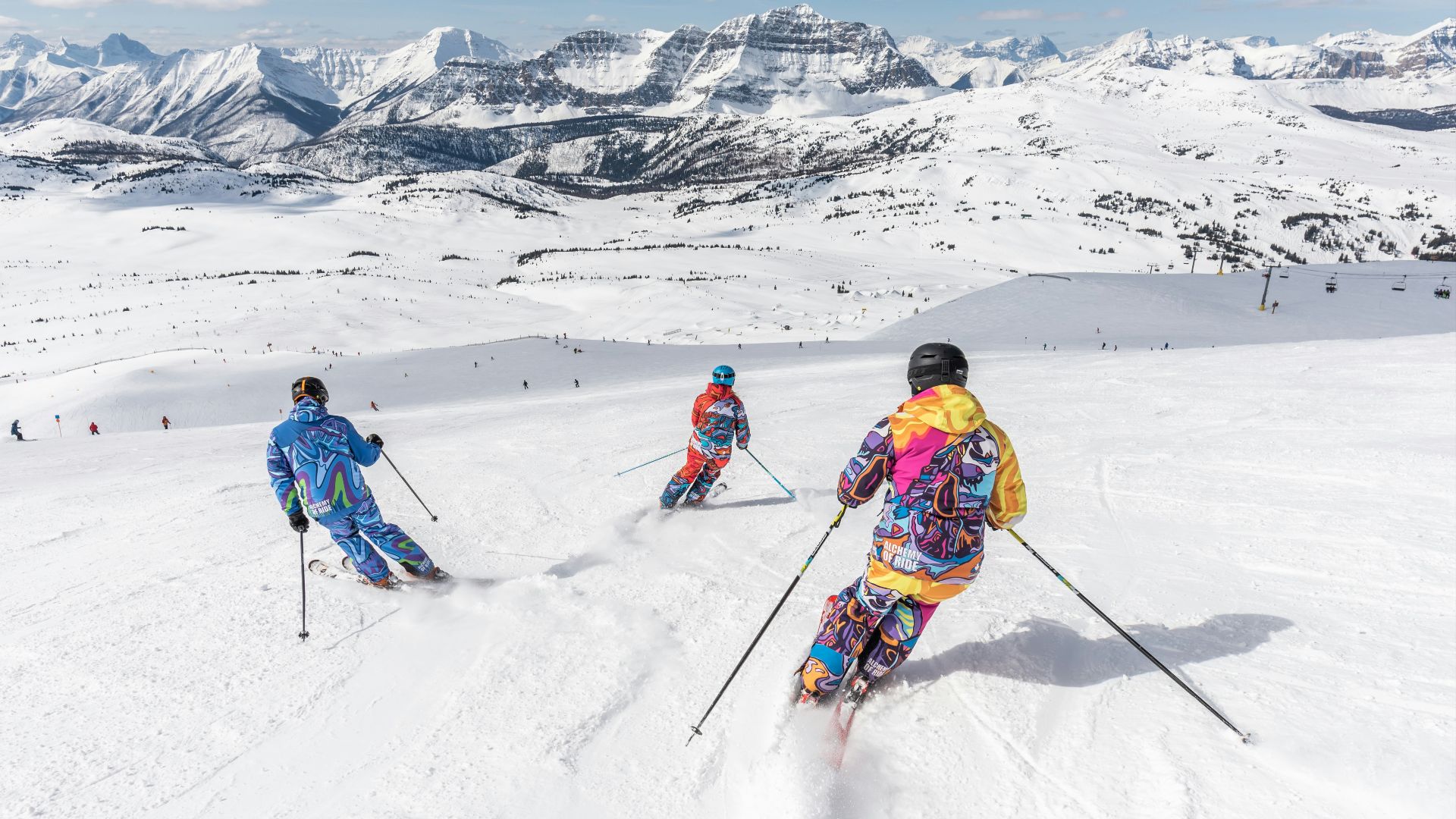 2 person in yellow jacket and blue helmet riding ski blades on snow covered mountain during