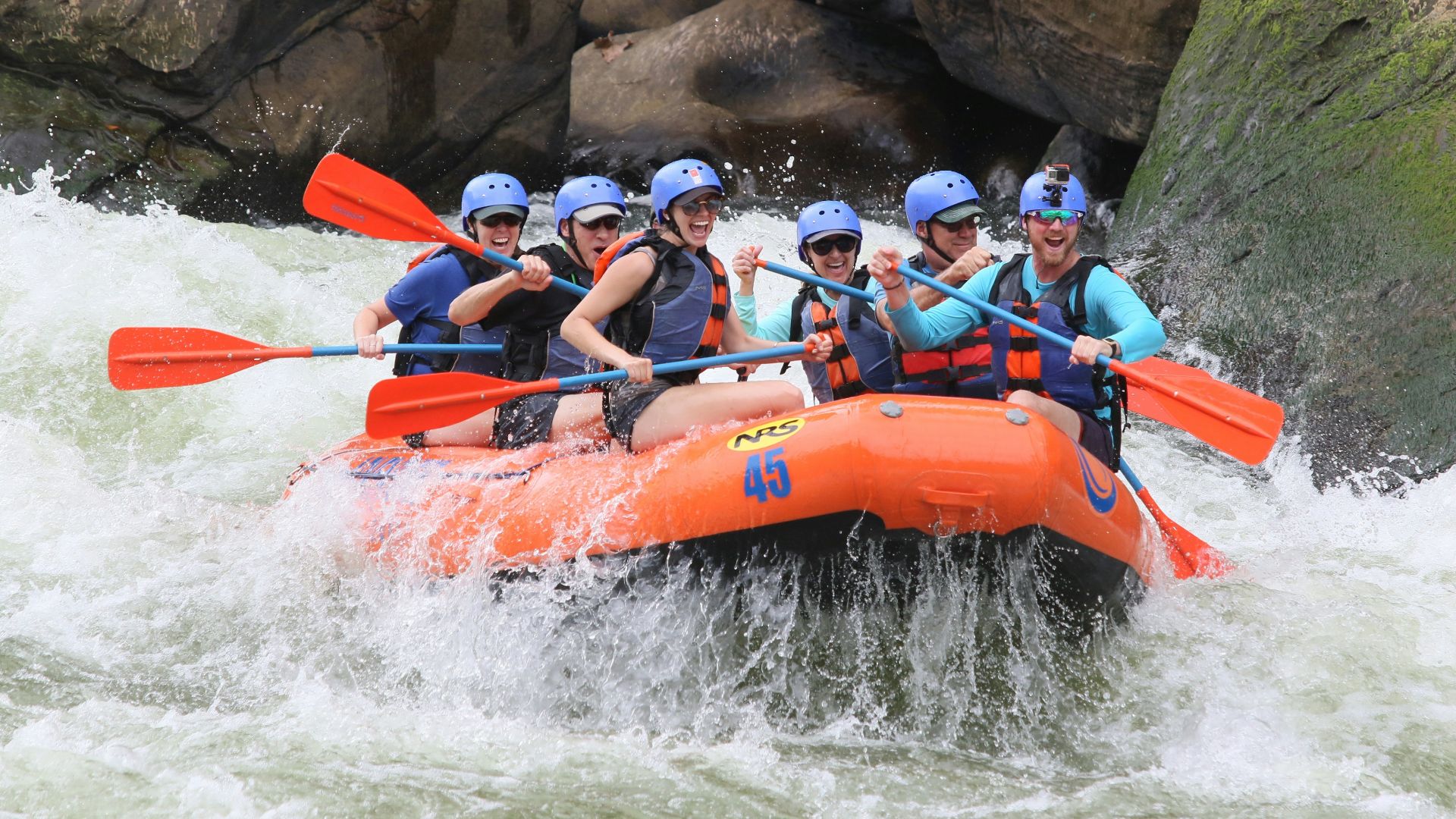 people riding orange kayak on river during daytime