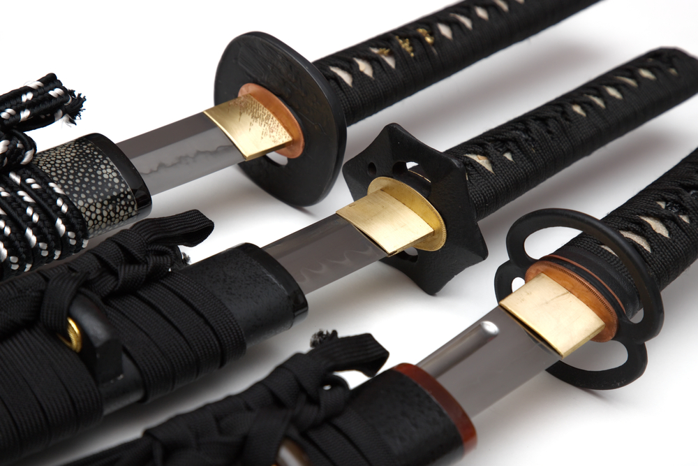 Three Japanese swords were drawn, showing part of the blade.
