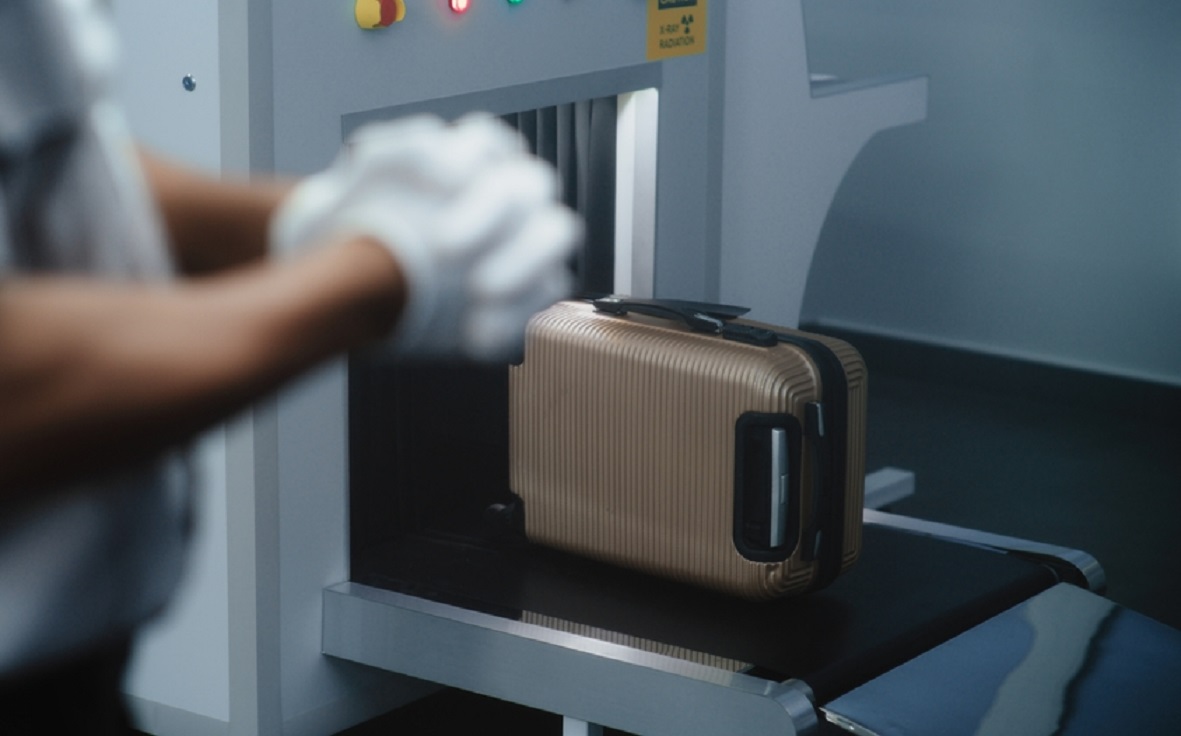 Security Officer Putting on Gloves Preparing for TSA Baggage Screening Procedures
