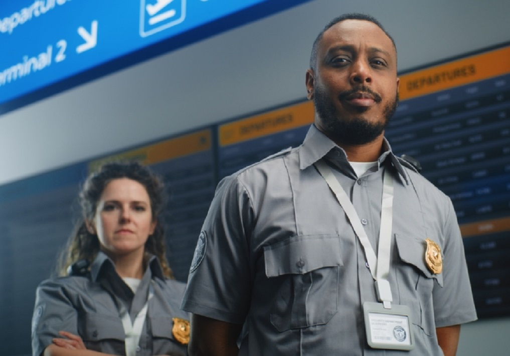 Portrait of Professional TSA Workers in International Airport Terminal
