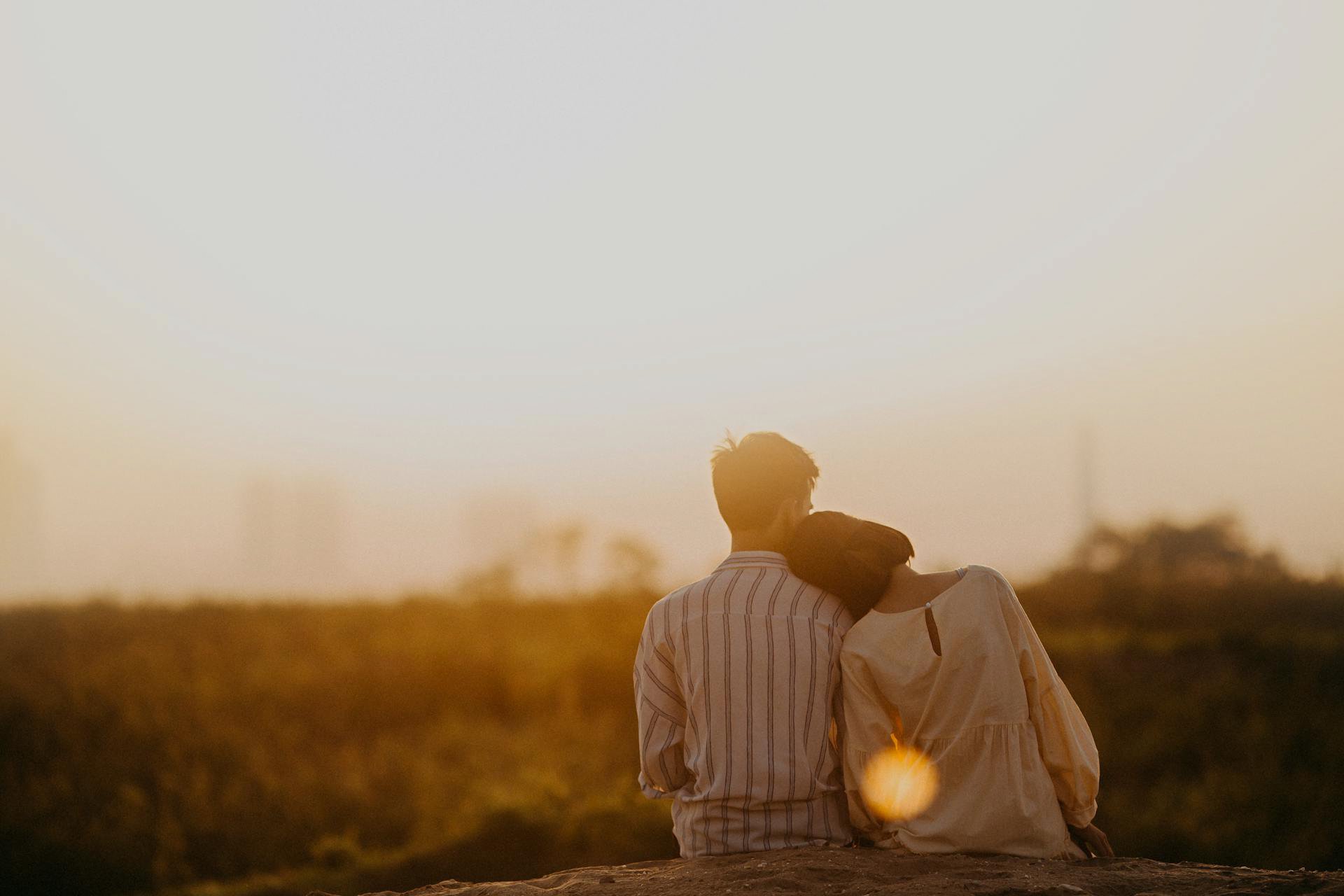 Man and Woman Near Grass Field