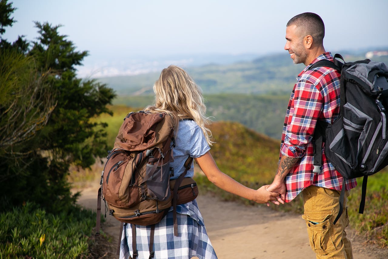 Couple with Backpacks Holding Hands