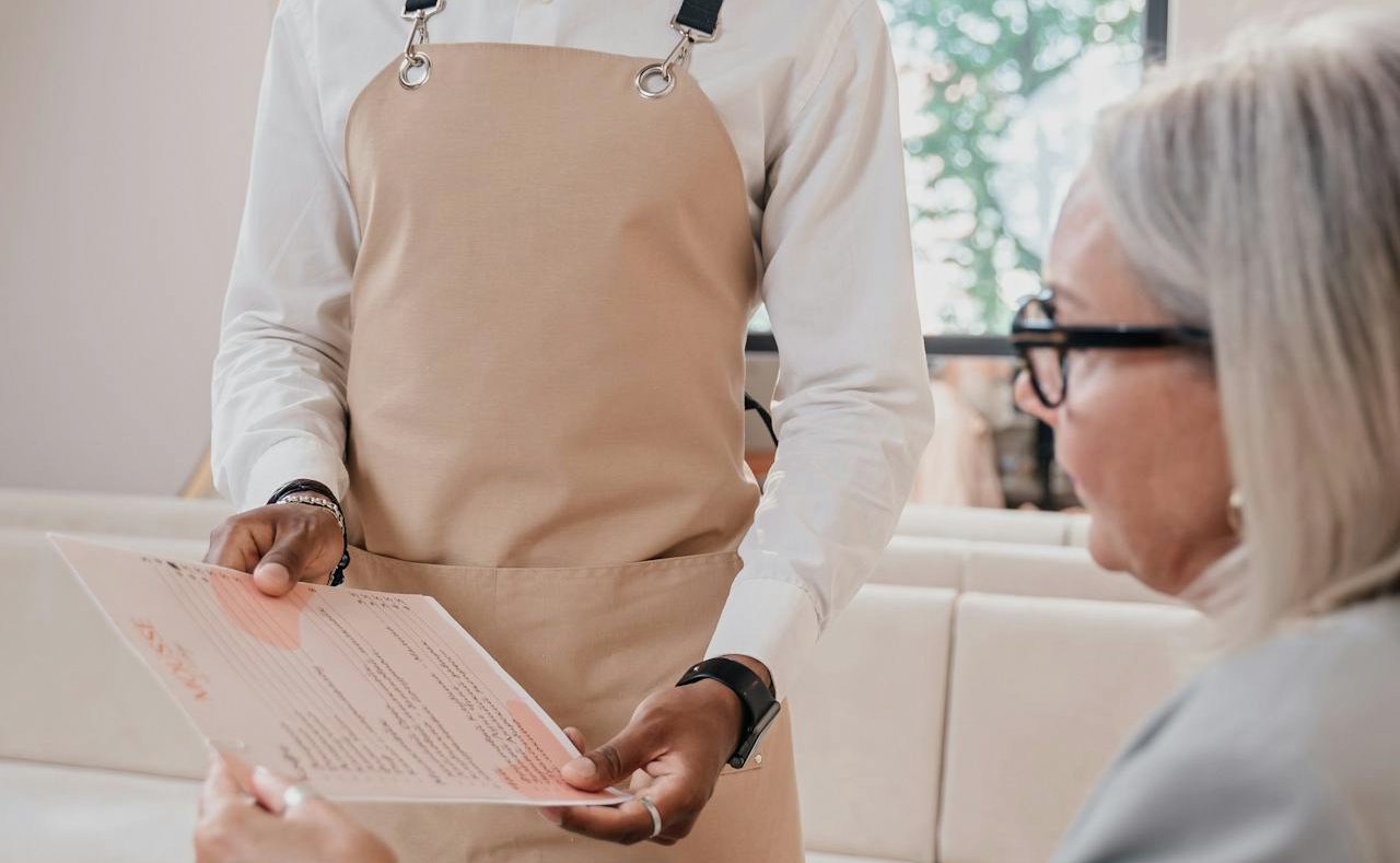 Waiter Showing Menu to Woman