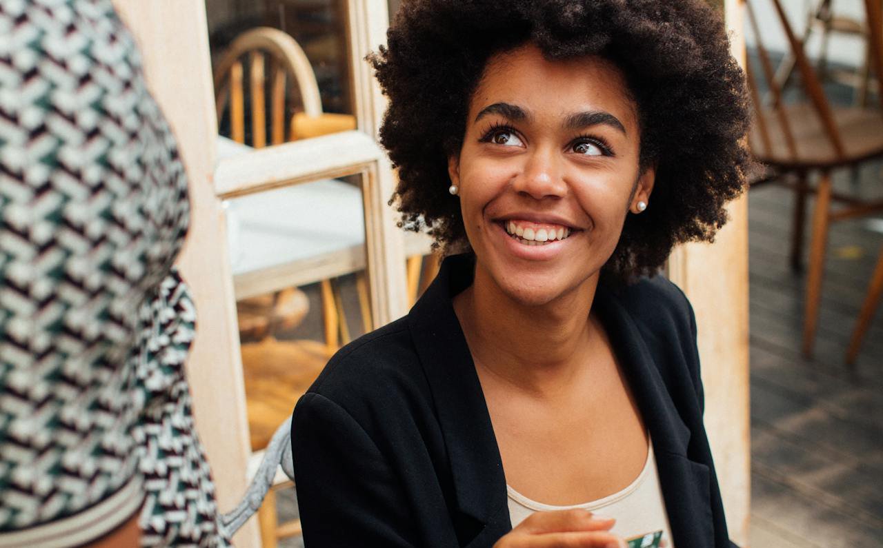 Smiling Woman Paying the Waiter