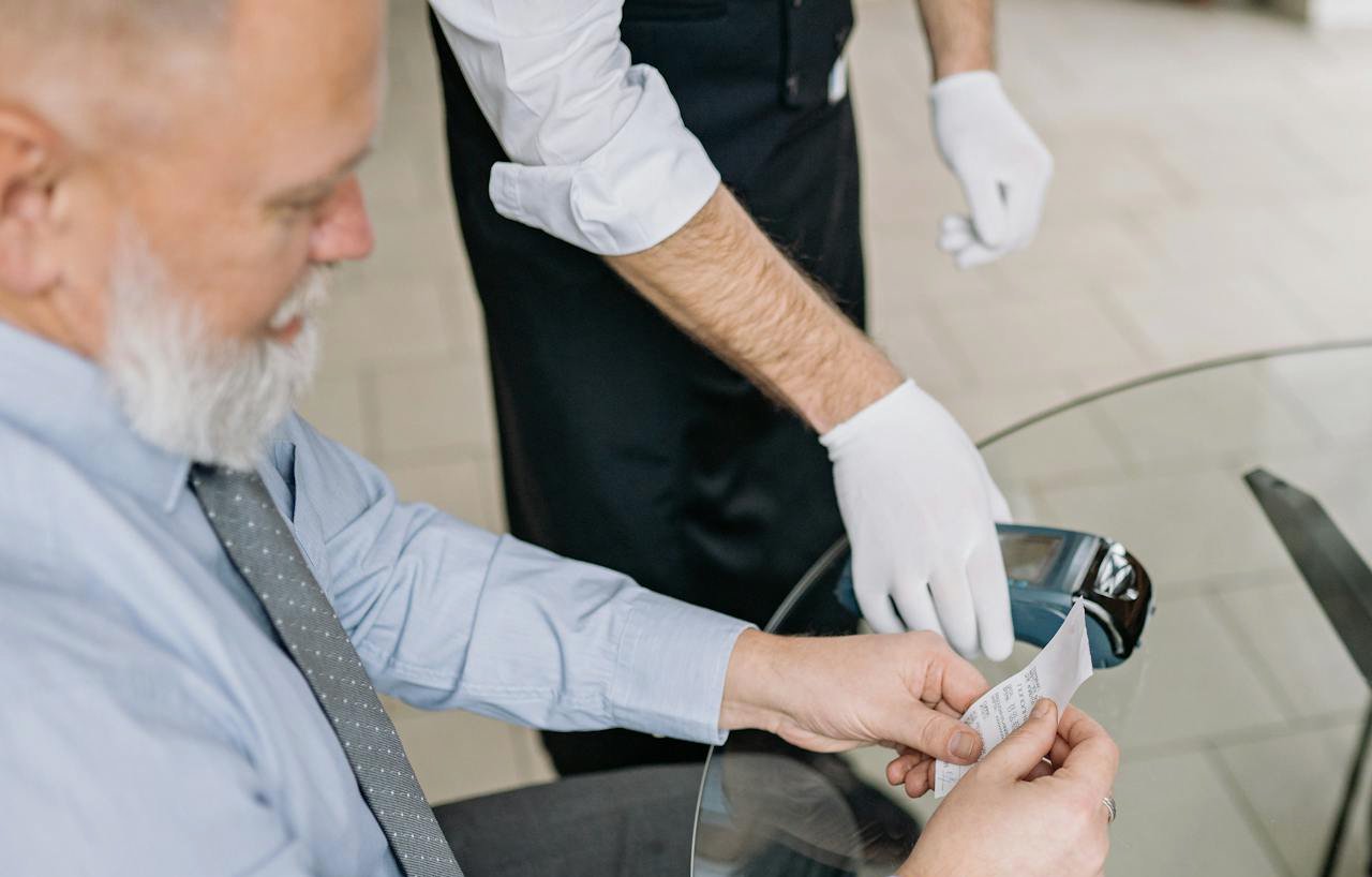 Close up of a Man Paying a Bill