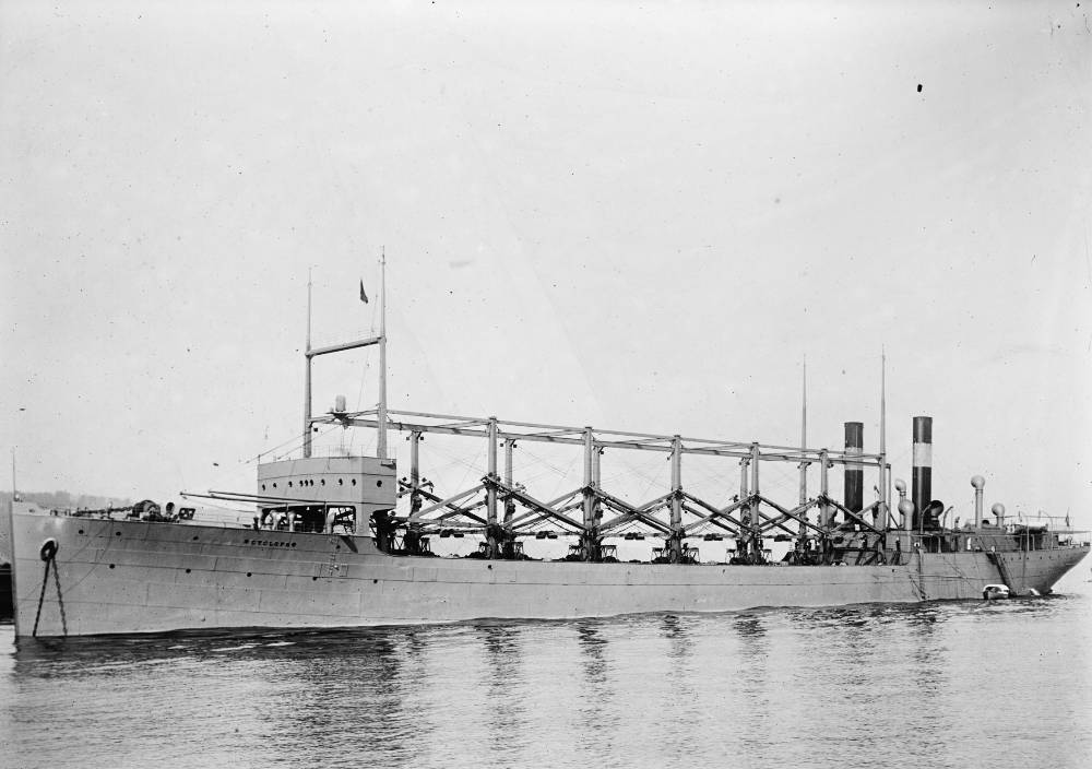 Grayscale Close Up Photo of USS Cyclops Anchored on a Dock