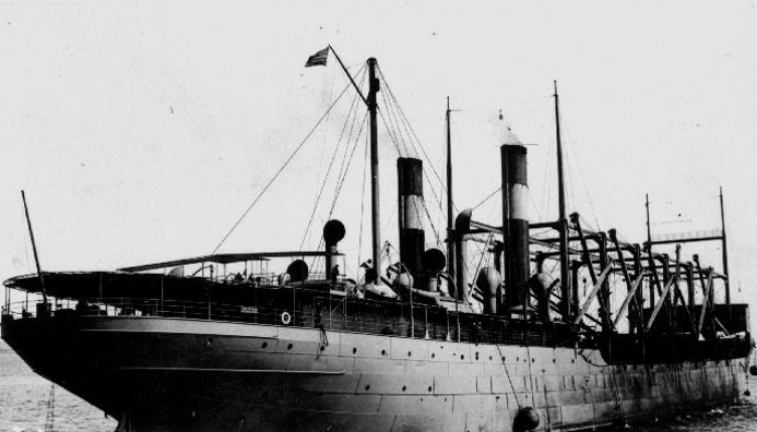 Grayscale Close Up Photo of USS Cyclops Anchored on a Dock