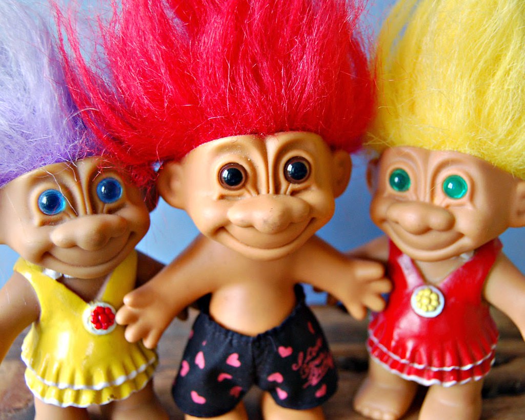 Mini troll dolls on table