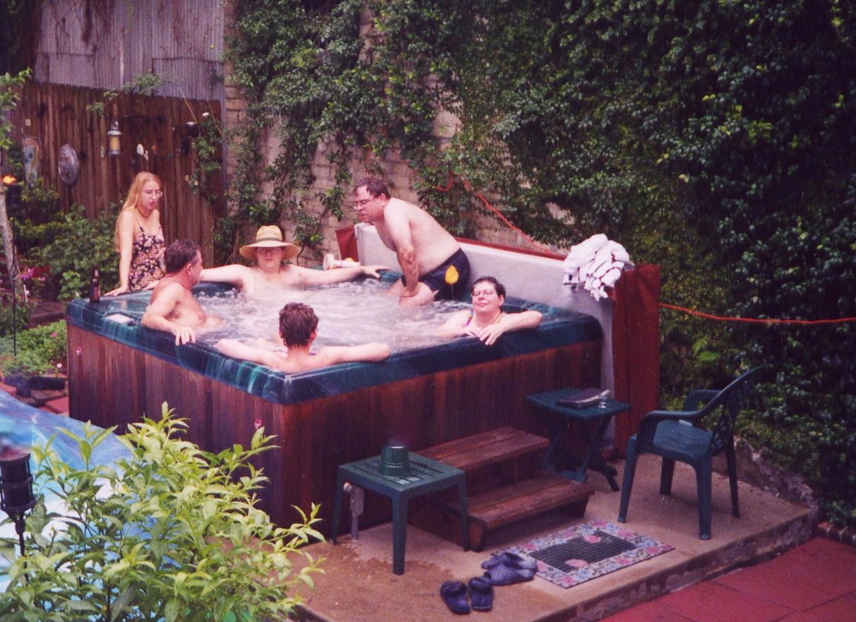 People at jacuzzi in the back yard.