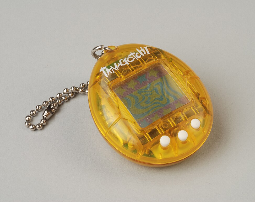 Tamagotchi - Yellow, egg-shaped toy on a metal chain