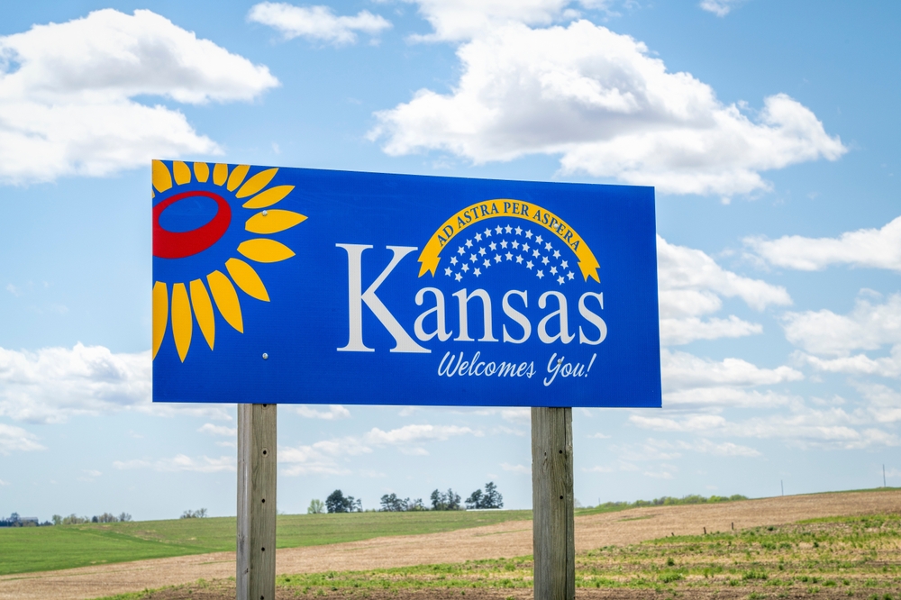 Kansas welcomes you - welcome roadside sign with a popular Latin phrase ad astra per aspera