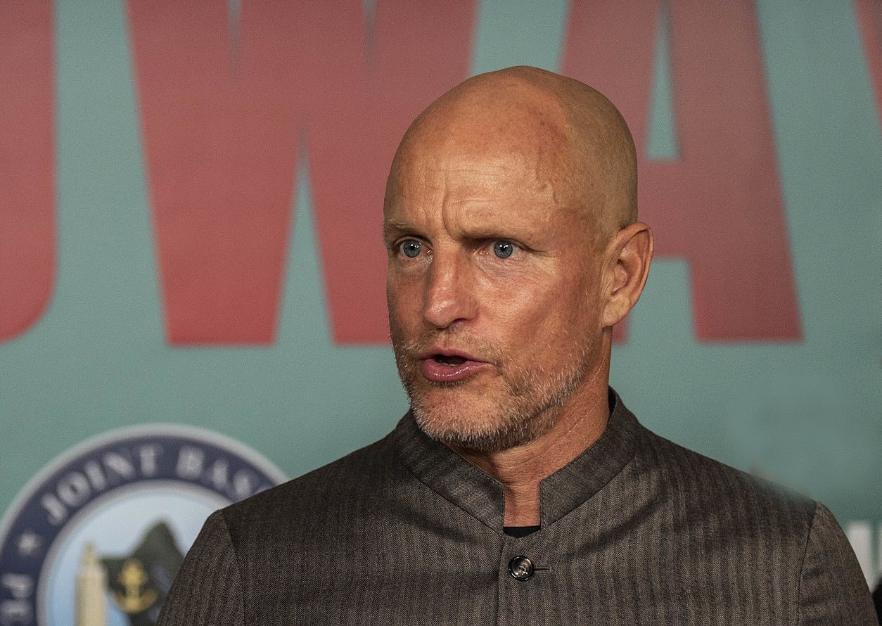 Woody Harrelson wearing a grey shirt