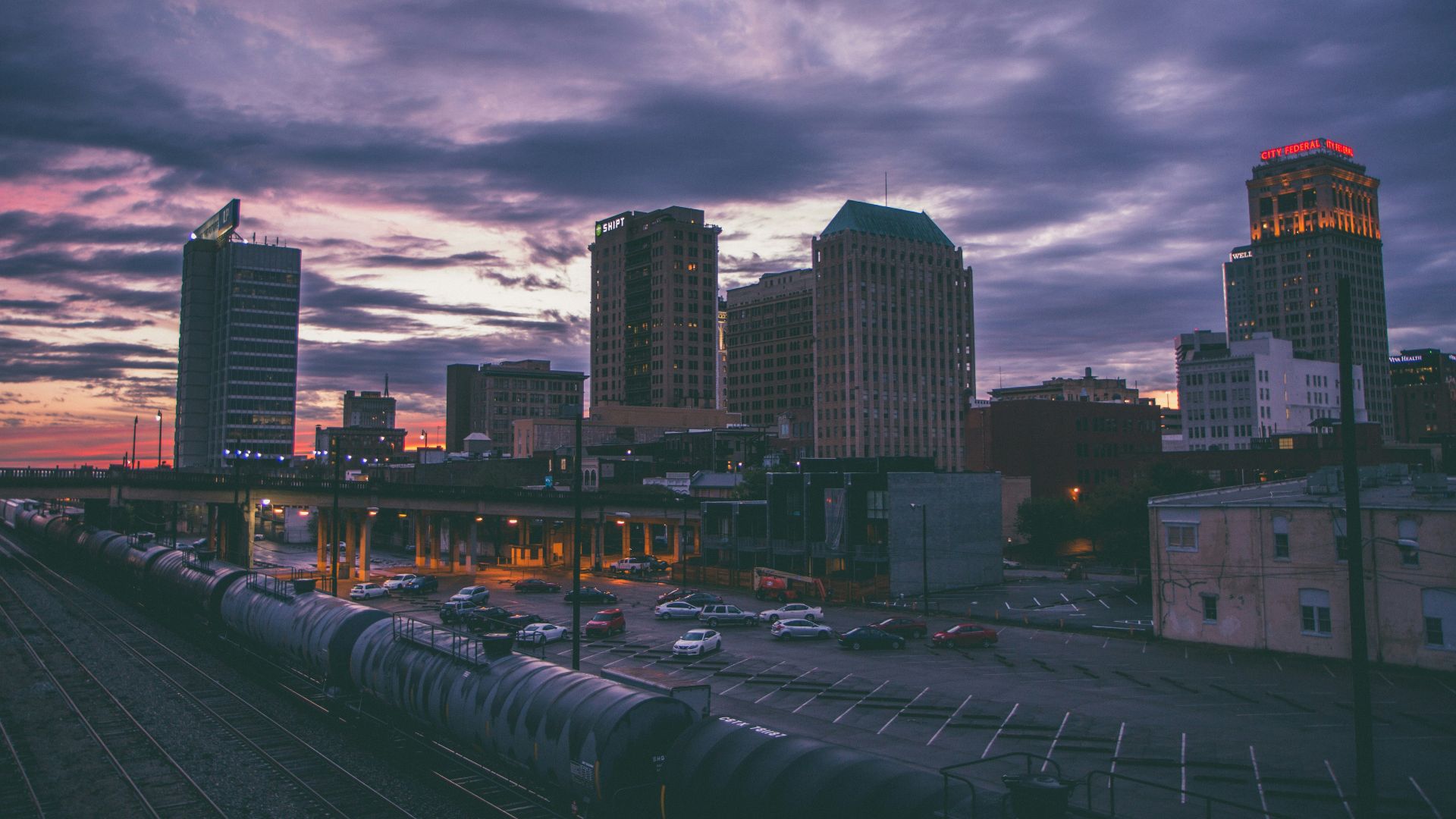 bird's eye view photography of high-rise buildings and train station