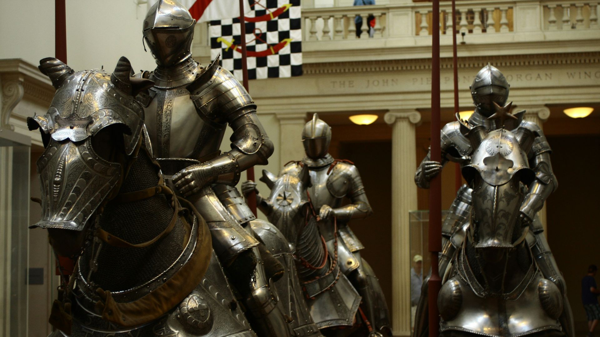3 men in gold and black suit statue